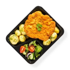 Kotletmielonyzziemniakamidomowyobiad Crispy fried chicken on top of boiled new potatoes with dill in a black takeout tray